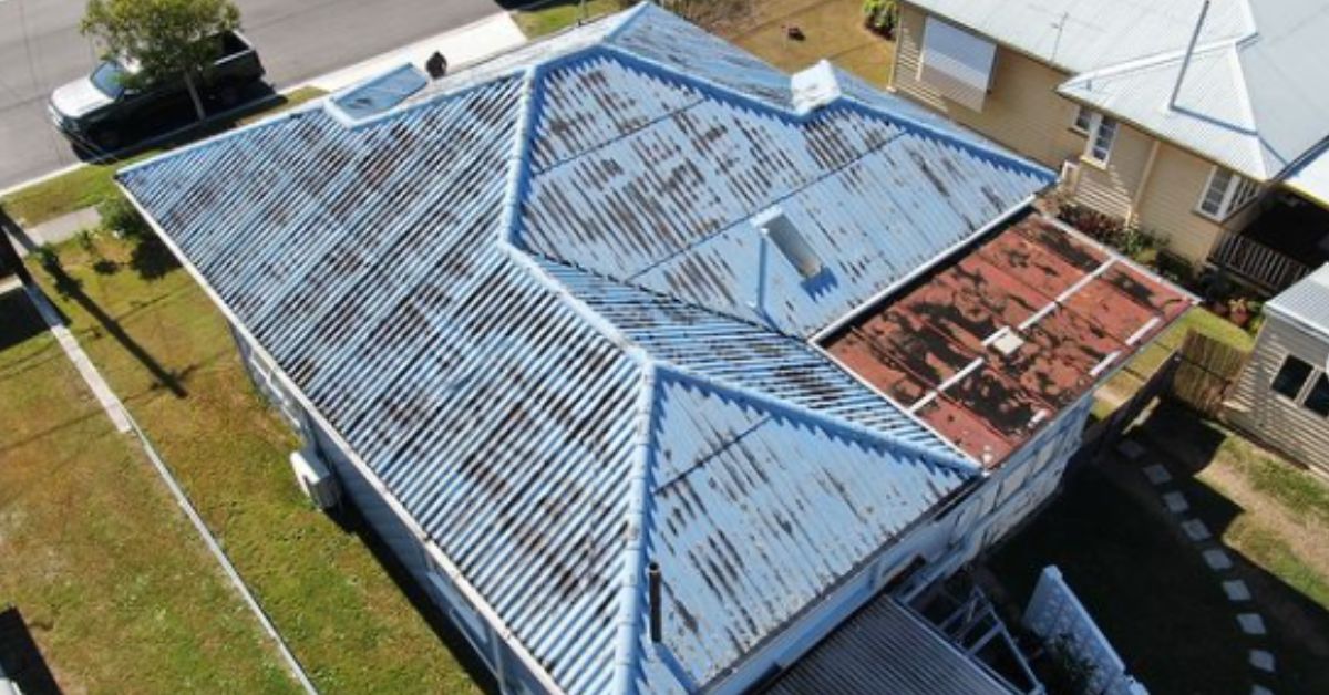 A large house with an asbestos roof on it